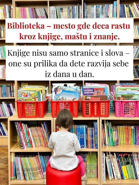 Dete sedi na crvenom taburetu okrenuto leđima i bira među knjigama, a ispred su crvene korpe sa slikovnicama.