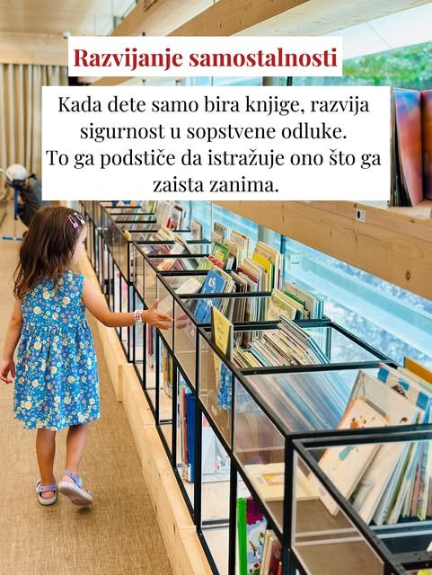 Devojčica u plavoj cvetnoj haljini prolazi pored staklenih polica i prstom dodiruje knjige koje želi da izabere.