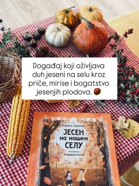 Knjiga leži na stolnjaku na kockice, okružena bundevama, kestenovima, klipom kukuruza i šipurkom.