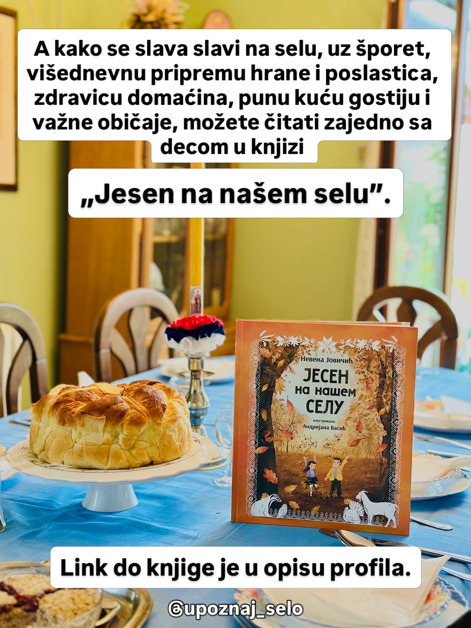 Knjiga „Jesen na našem selu“ stoji na plavom stolnjaku, pored slavskog kolača i sveće sa trobojkom.